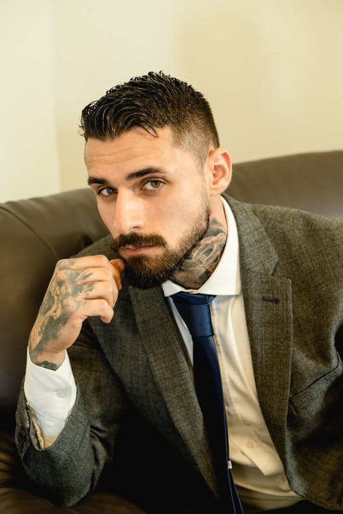 Portrait of a Man with Tattoos Wearing a Gray Suit