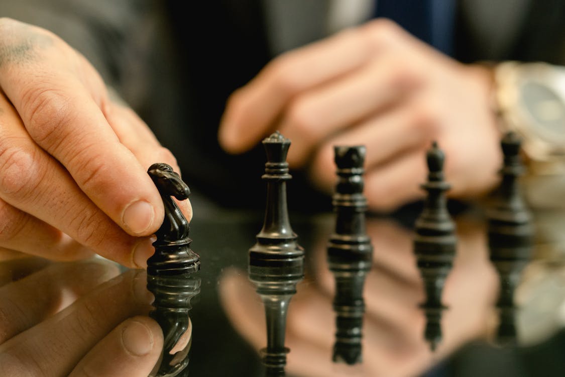Free Photo of a Person's Hand Holding a Chess Piece Stock Photo