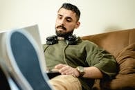 Low Angle Shot of Man Sitting on Brown Sofa
