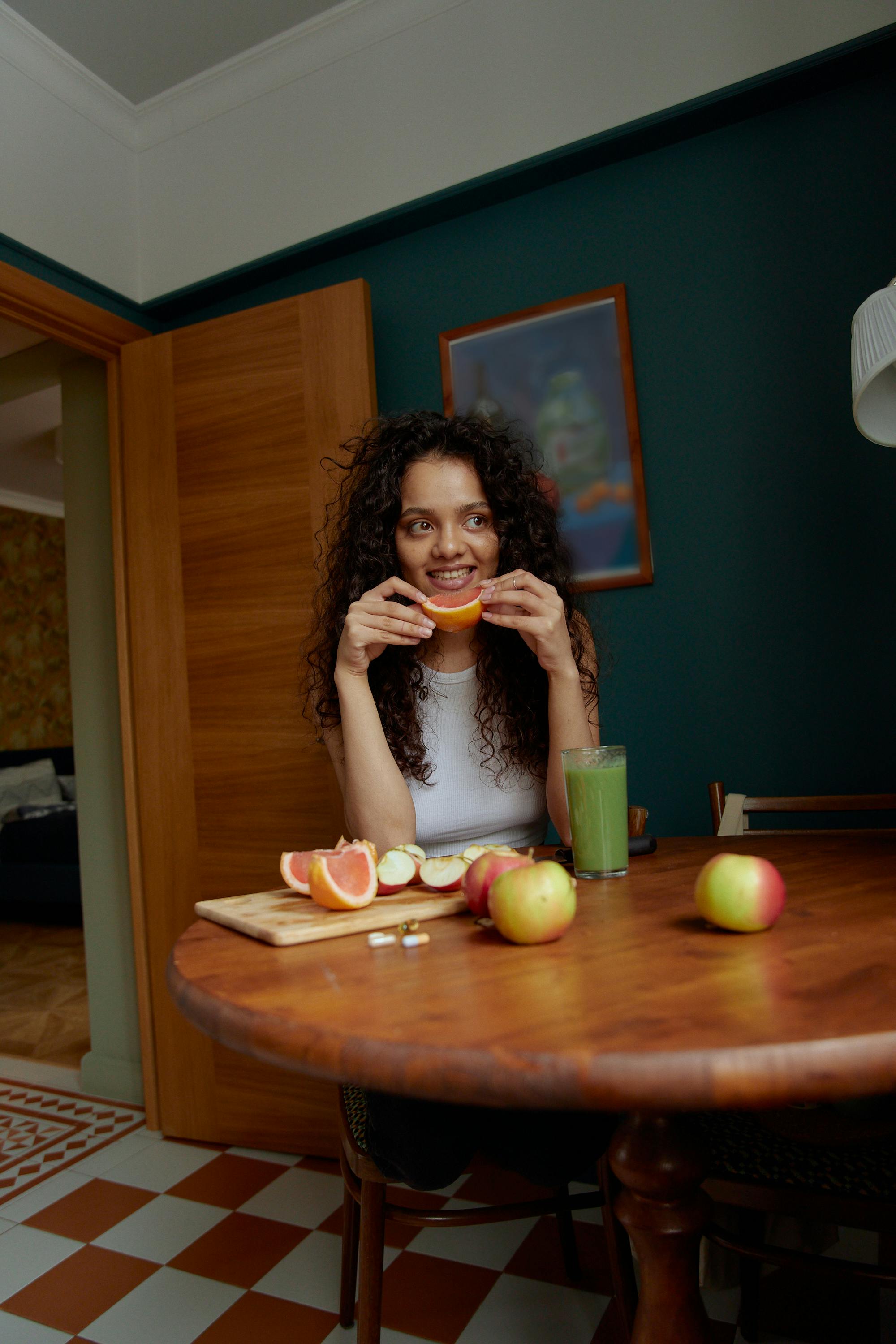 Woman in Black Tank Top Eating