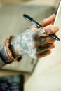 Person Holding Pen Writing on Paper