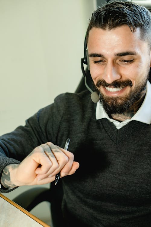 Photo of a Man with Facial Hair Wearing a Headset