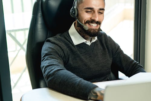 Man Wearing Headset while Working at the Office