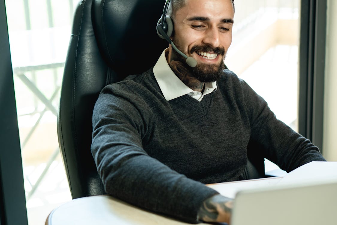 Man Wearing Headset while Working at the Office