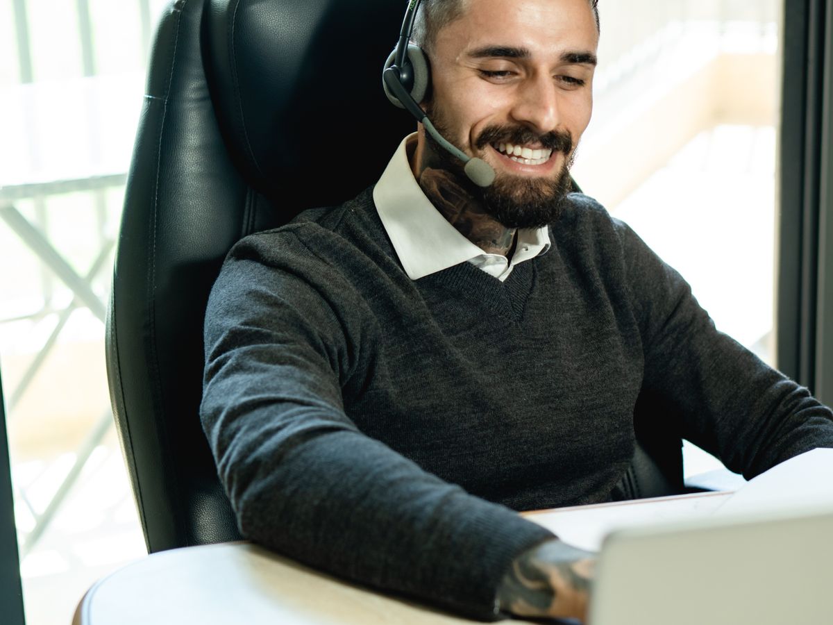 A customer support professional working with a headset