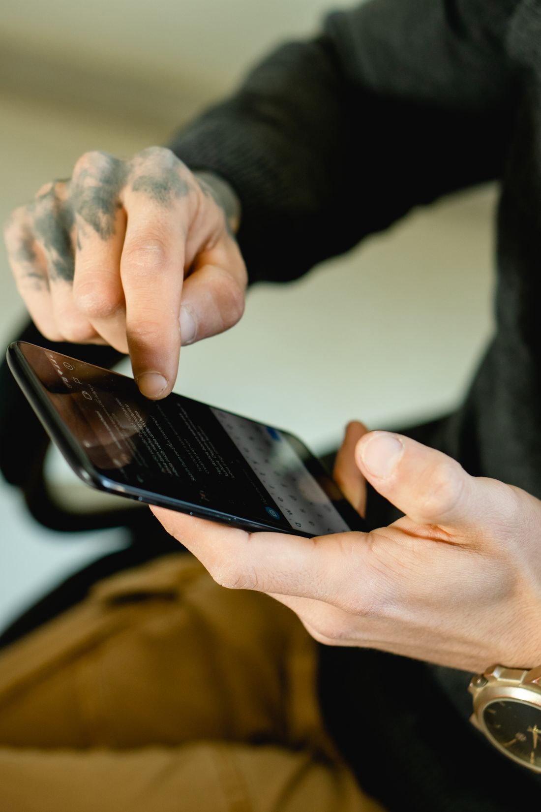 Hands type a message on a smartphone.