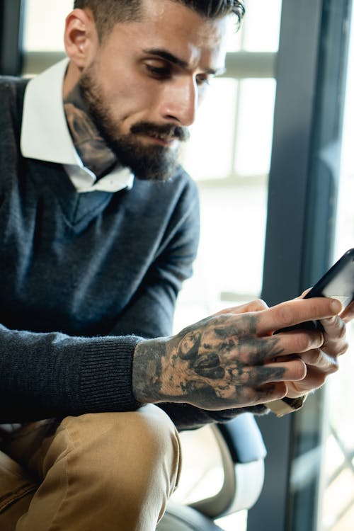 Bearded Man Holding a Smartphone