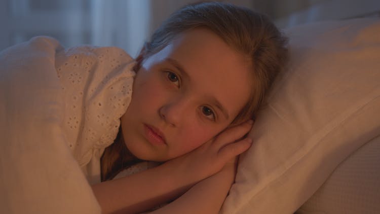 Photograph Of A Girl Lying On A Pillow