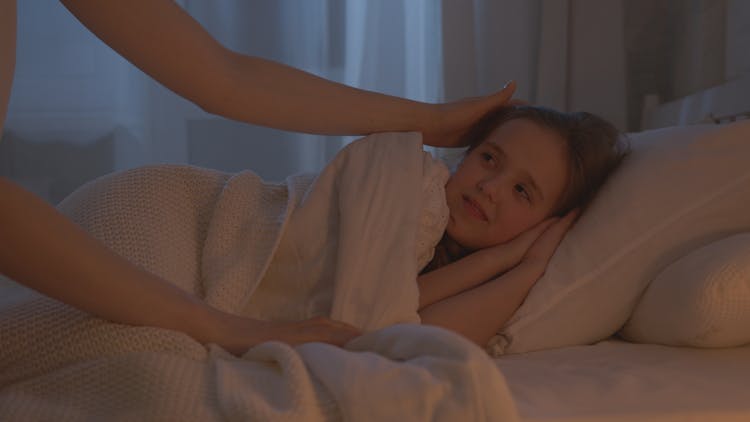 Photo Of A Kid Lying On A Bed