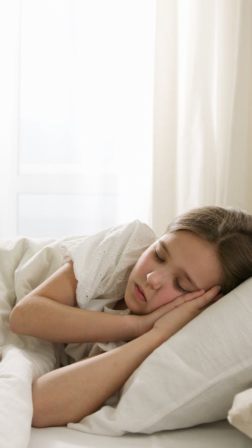 Free Kid Sleeping on Bed Stock Photo