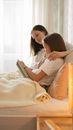 Woman in White Shirt Lying on Bed Reading Book