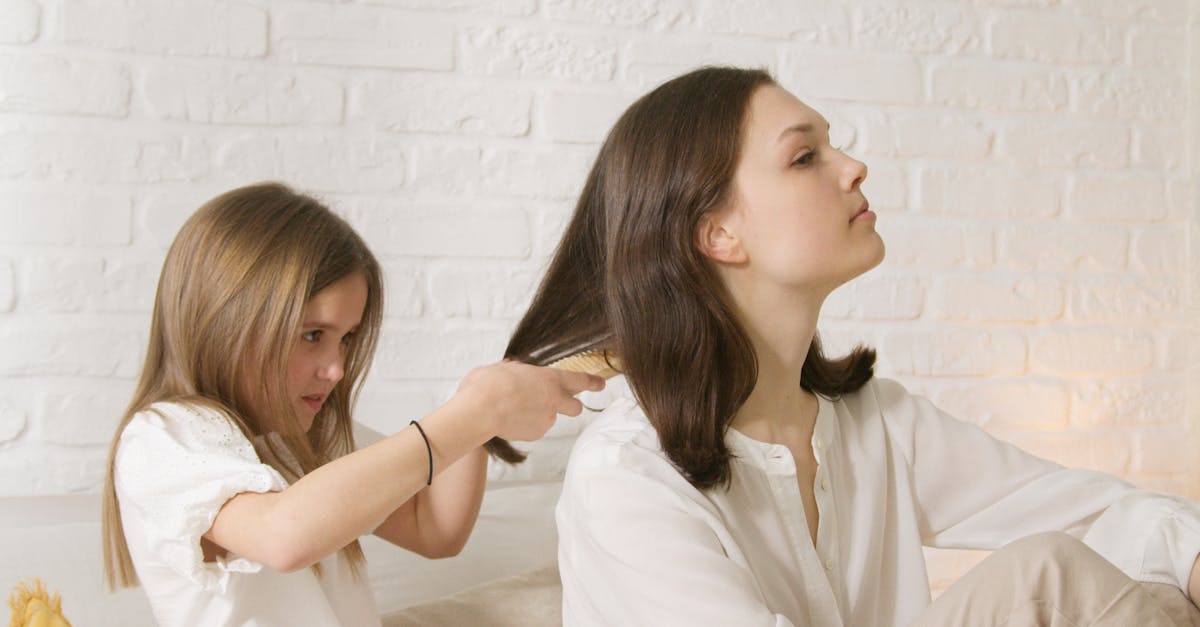 Woman in White Dress Shirt Sitting on Bed