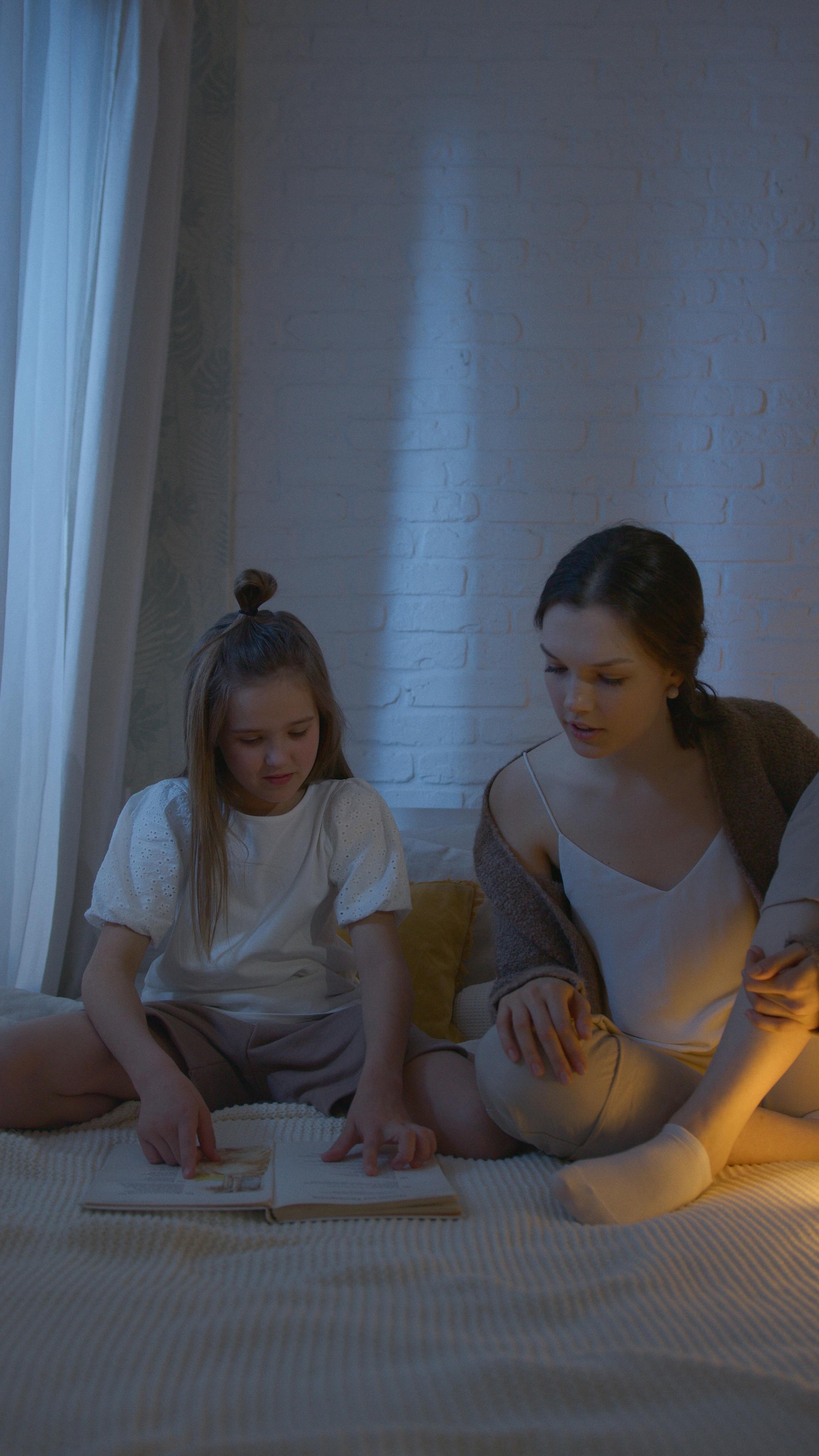 woman in white shirt sitting beside woman in white shirt