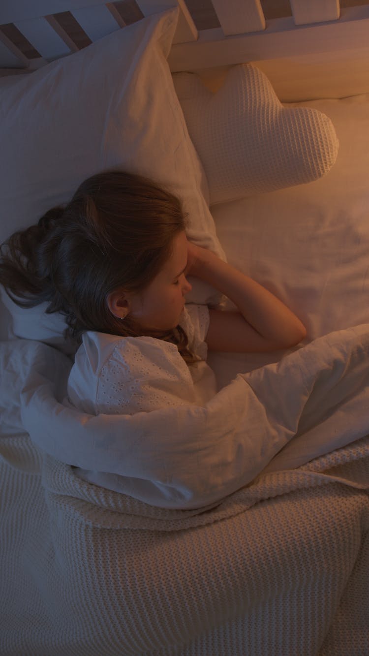 Girl In White Shirt Lying On Bed