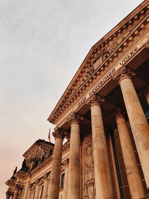 Free Low angle shot of Reichstag Building facade in Berlin, showcasing majestic columns at sunset. Stock Photo