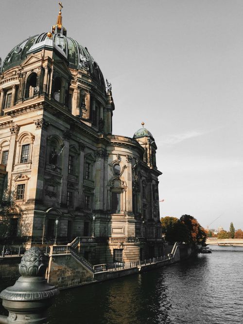 Free A scenic view of Berlin Cathedral by the river during a clear autumn day, showcasing its baroque architecture. Stock Photo