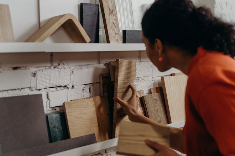 Woman Looking At Wood Samples On A Shelf