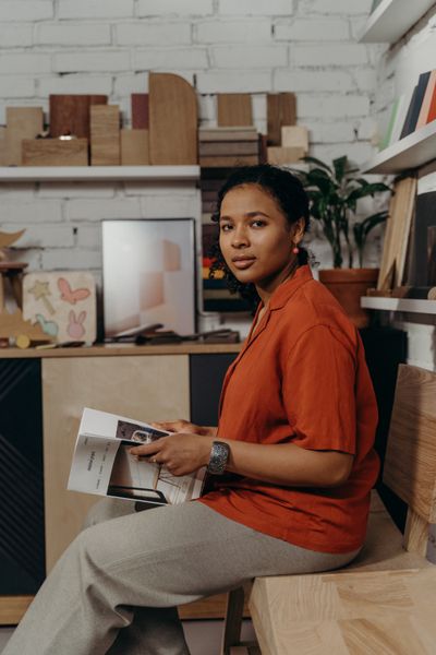 Celeste Arceneaux sitting in the studio with a sample book