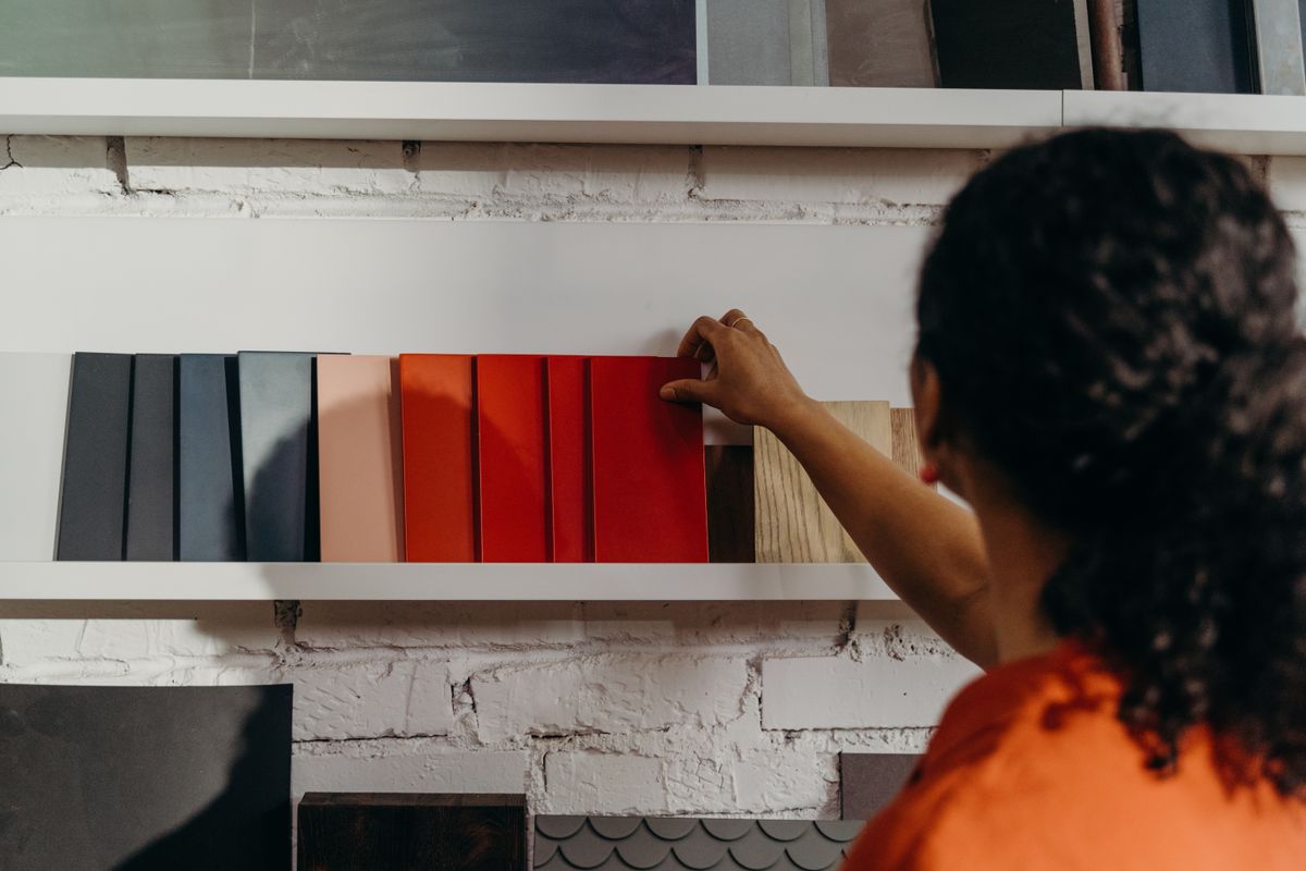 Customer browsing tile samples at One Click Enterprises showroom