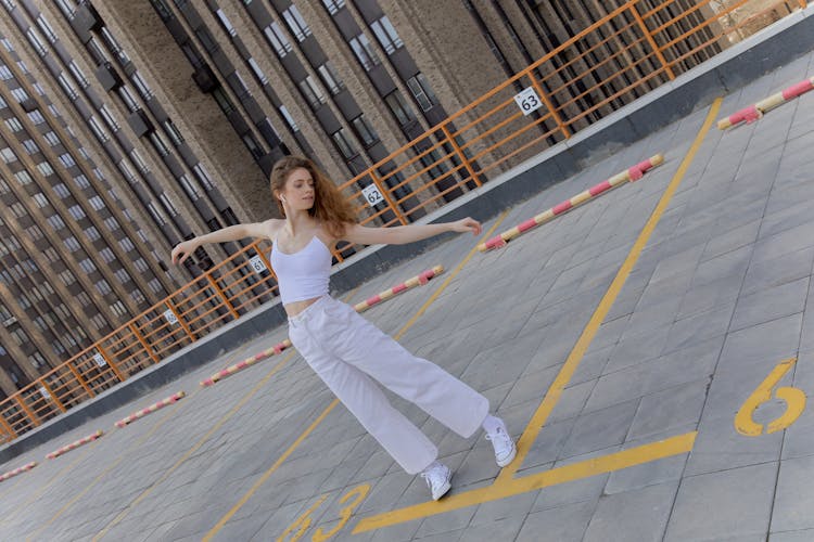 A Woman Dancing On The Parking Lot