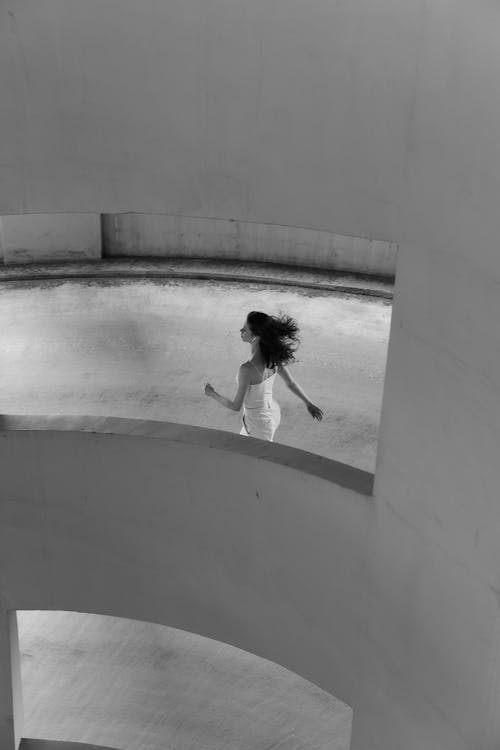 Free Woman Walking on Concrete Floor Stock Photo