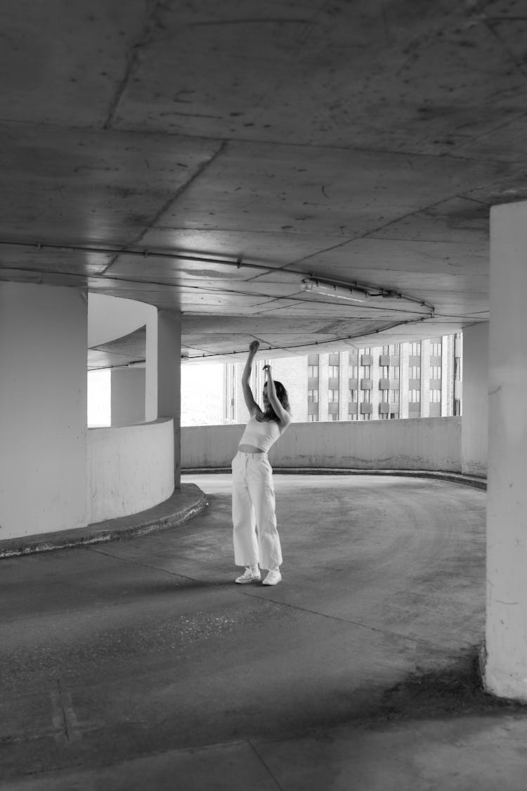 Woman Bending Back On Concrete Driveway