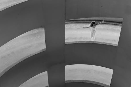 Free Grayscale Photo of Woman Dancing on Driveway of a Car Park Stock Photo