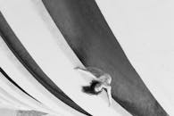 Woman Bending Backwards on Concrete Barrier