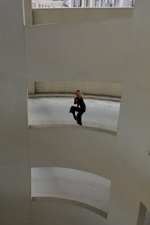 Woman Standing in Concrete Staircase