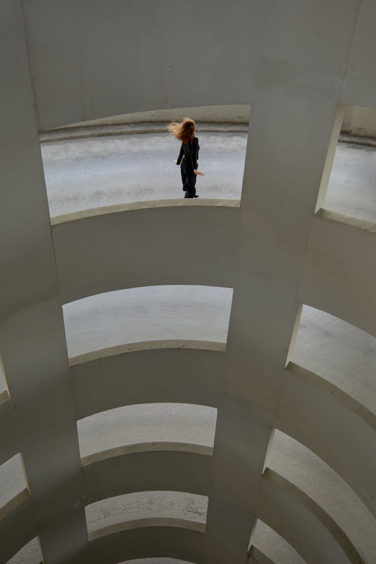 Woman Dancing At The Driveway Of A Car Park