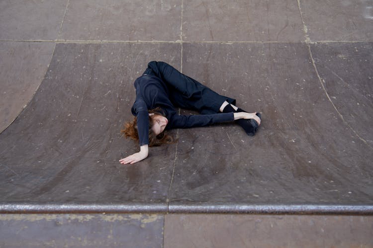 Flexible Woman Lying On A Ramp