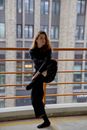 Photo of a Woman Dancing Near Railings