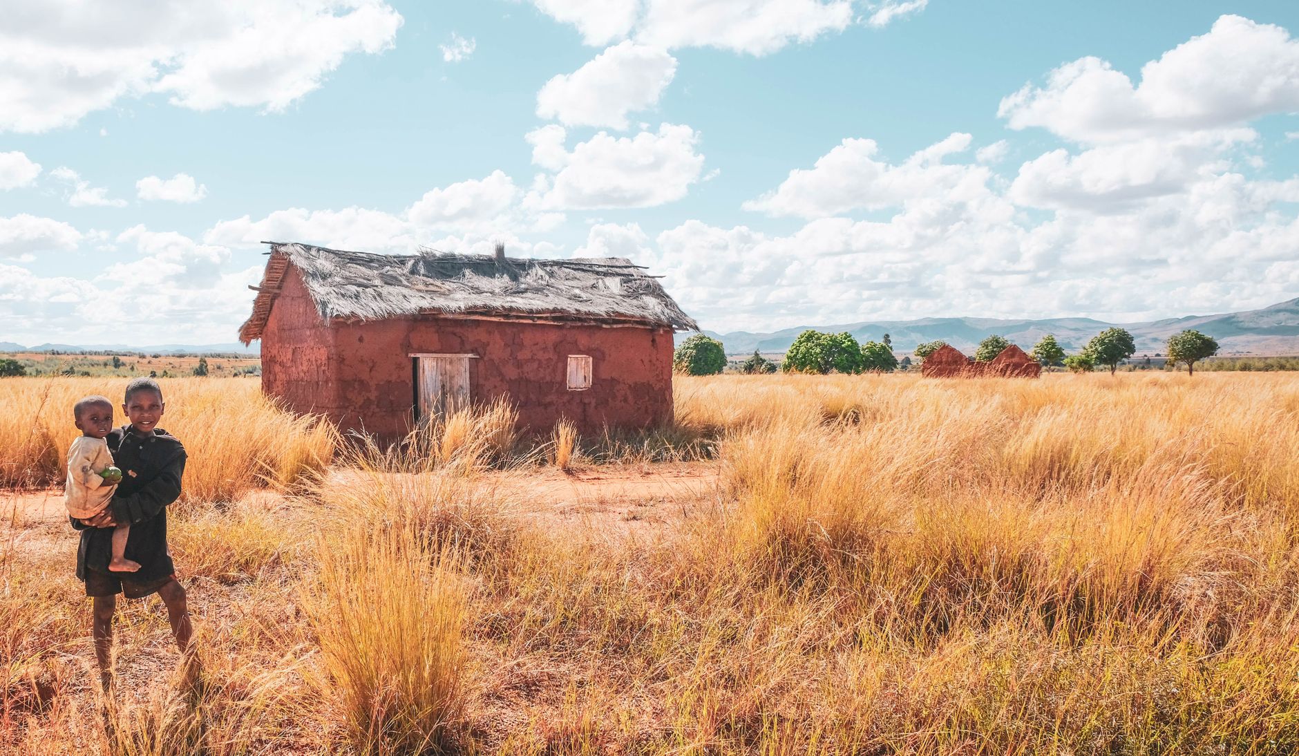 A rustic house in Madagascar's countryside with children playing in it.