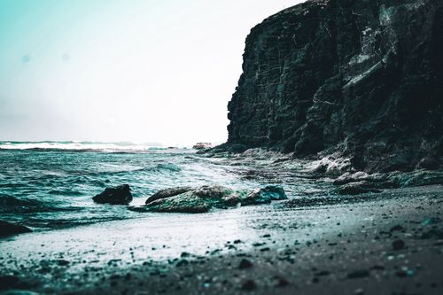 Free A striking seascape featuring rugged cliffs and crashing waves, capturing the raw power of nature. Stock Photo