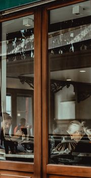 Cozy café scene in Istanbul with people reflecting through windows, offering a warm and inviting atmosphere.