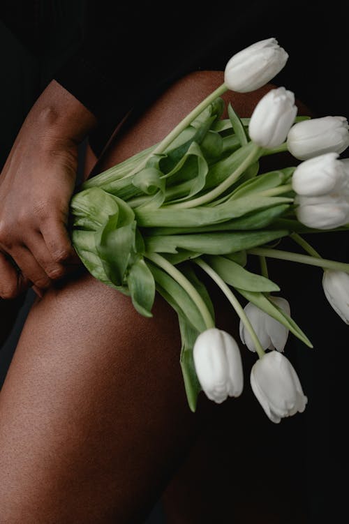 Woman Holding White Tulips