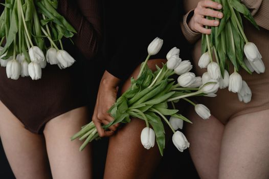 Woman in Black Long Sleeve Shirt Holding White Flowers