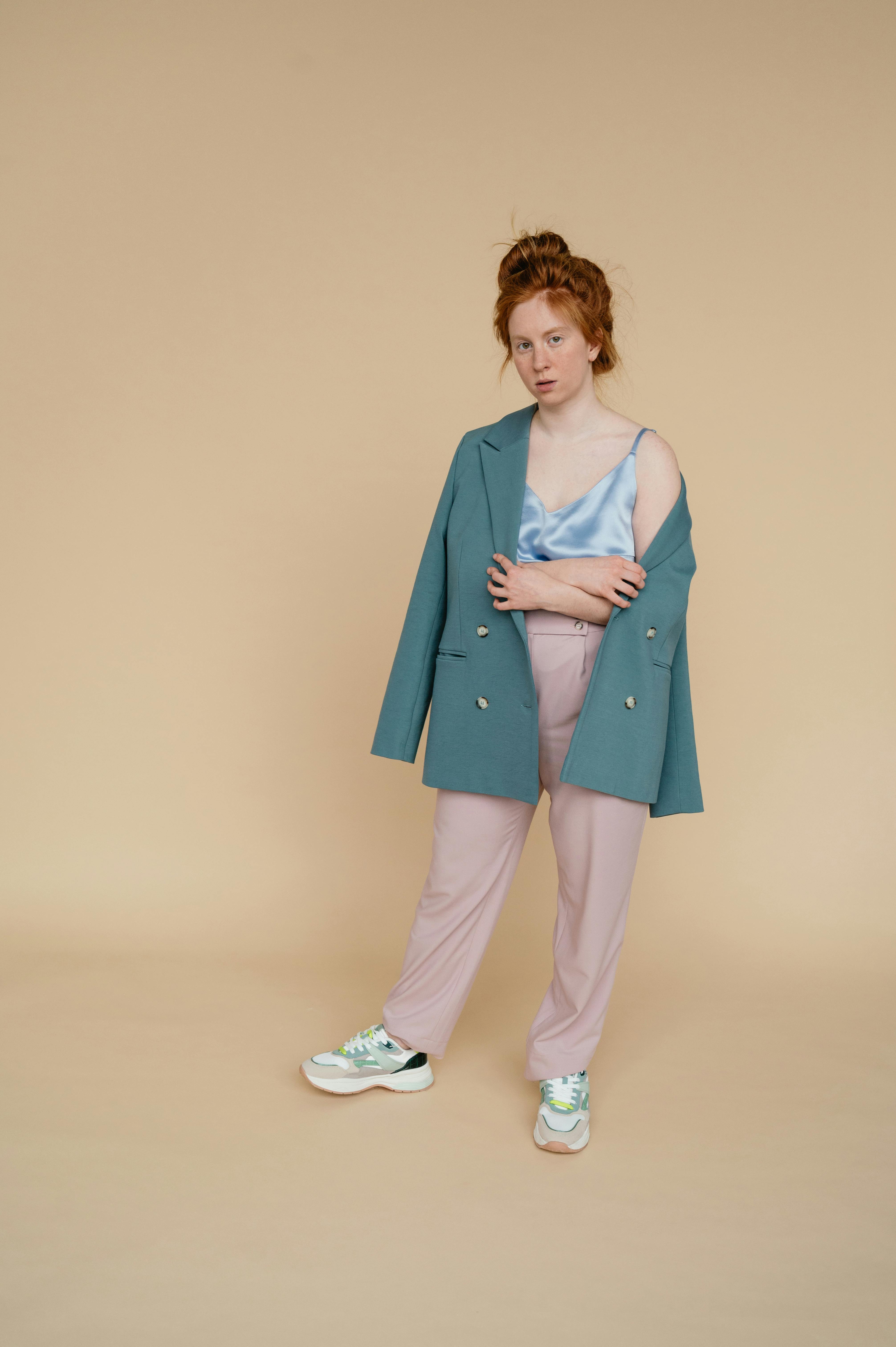 Redhead woman posing in stylish casual wear during a studio photoshoot.