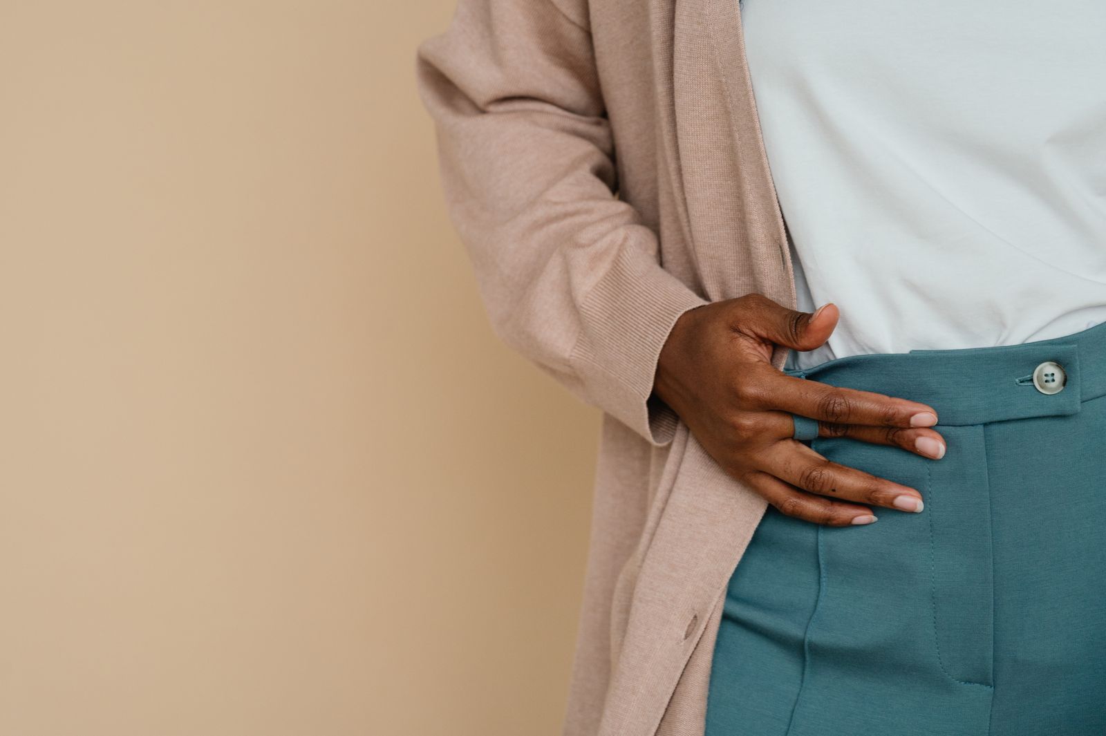 Person stretching their lower back in bright natural light