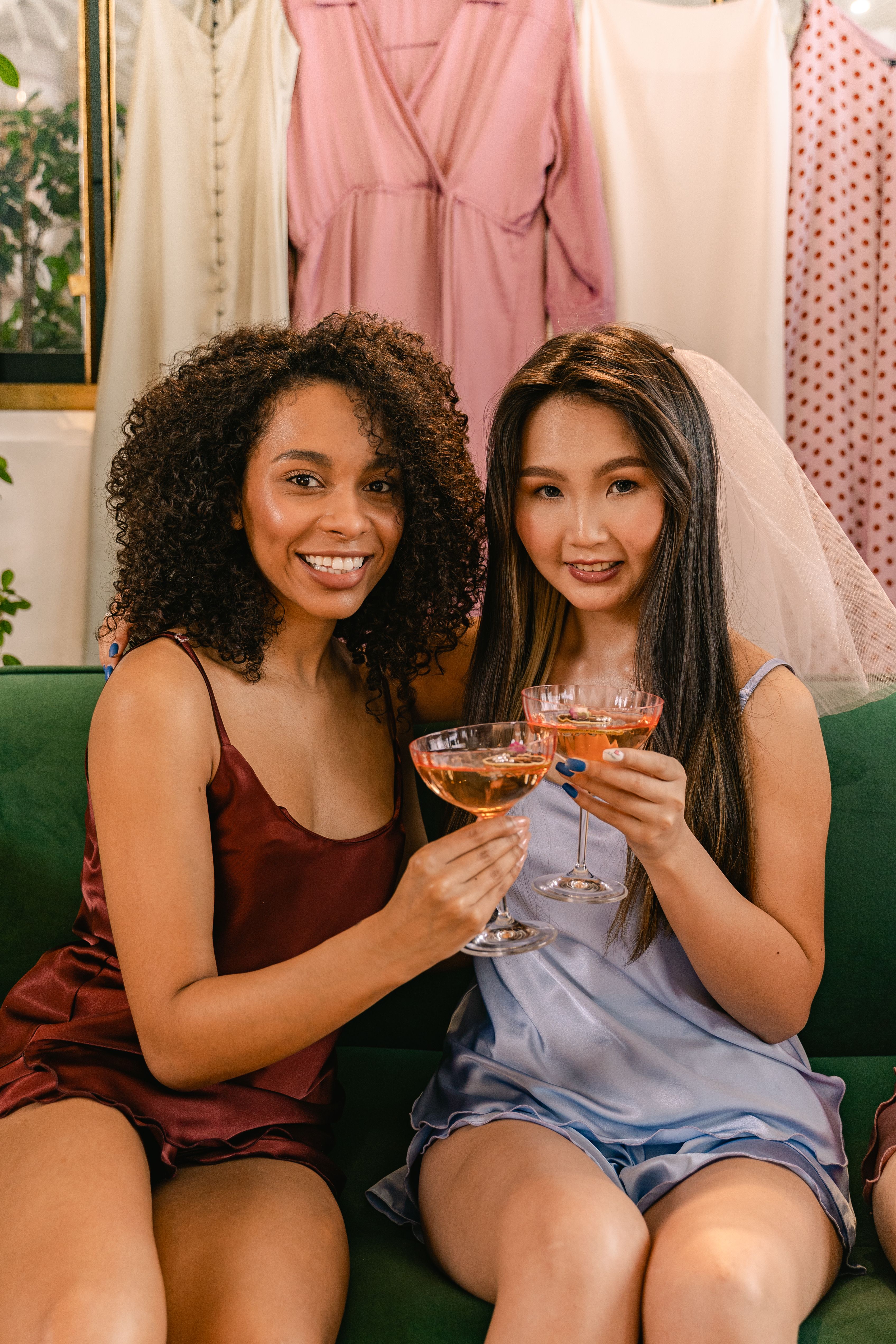 Two women enjoying a celebratory moment with champagne indoors, capturing joy and friendship.