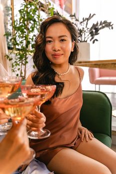 Elegant woman enjoying a toast with champagne in a luxurious indoor setting.