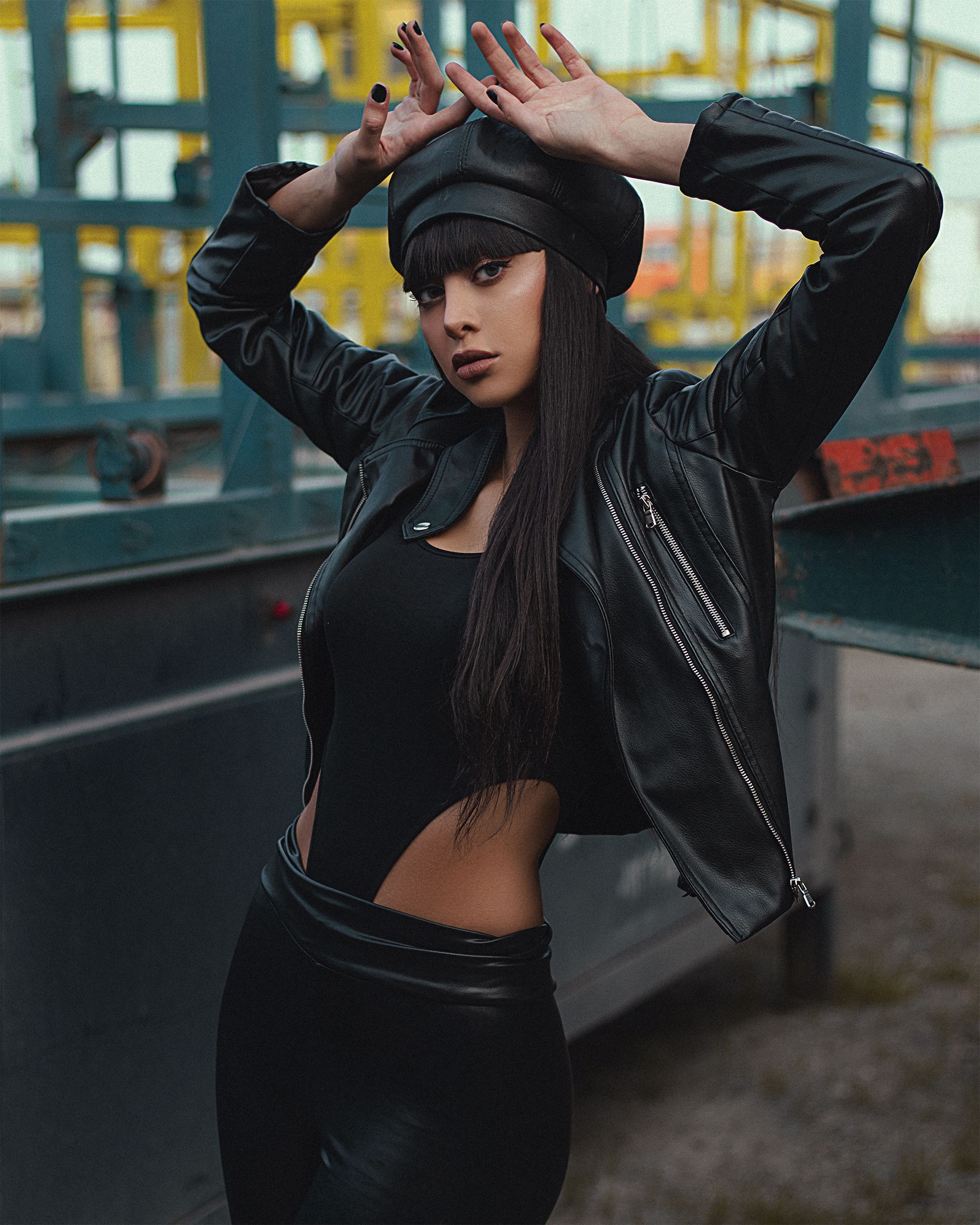 Woman in a Black Leather Jacket Posing with Her Hands on Her Head ...