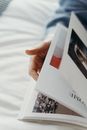 Person Turning Pages on the Magazine