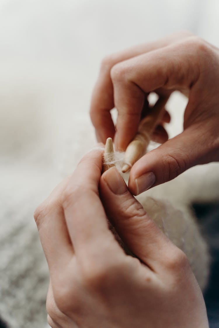 A Person Knitting With Knitting Pins