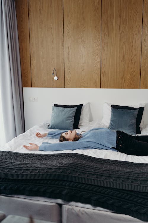 A Woman Lying Down on a Bed