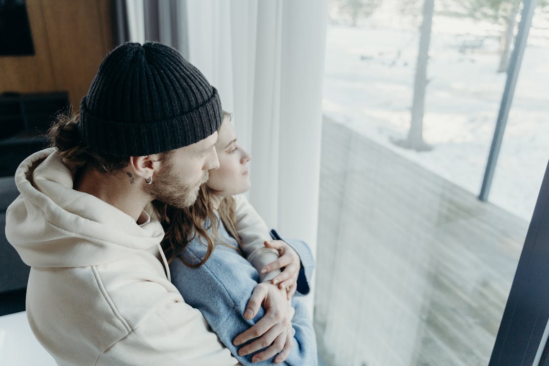 Free Man Wearing Black Beanie Hugging a Woman Stock Photo