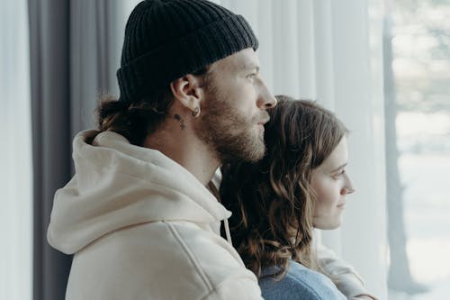 Free Man and Woman Looking Outside Stock Photo