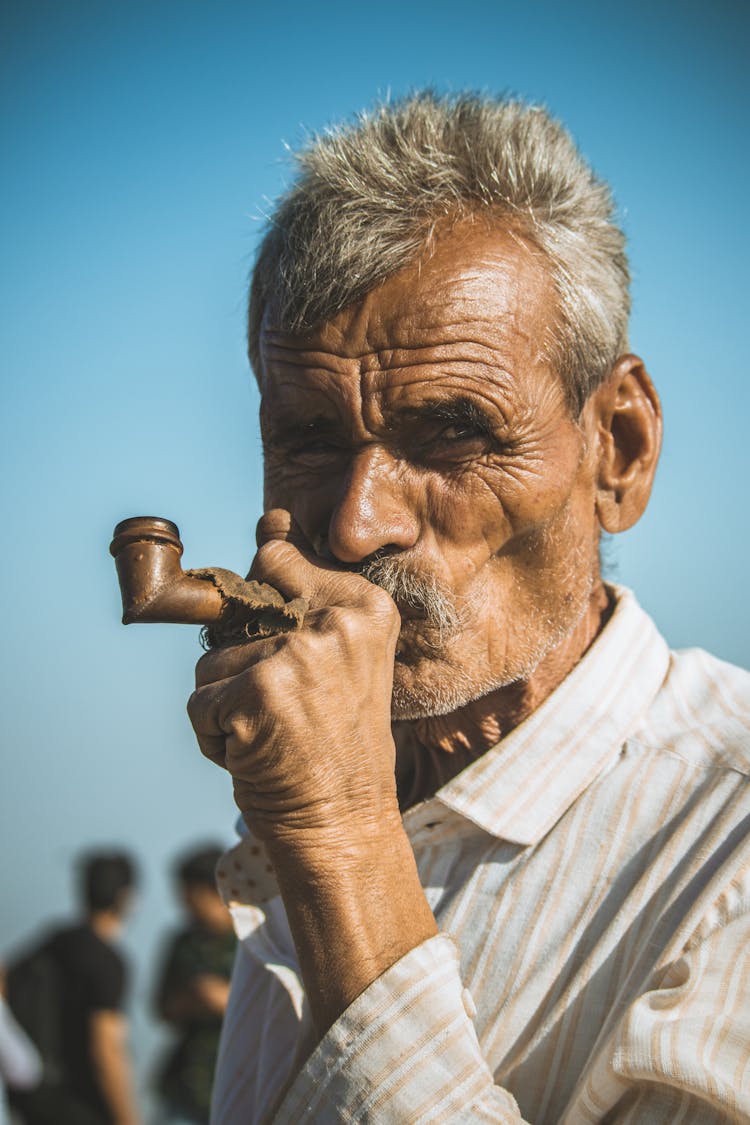 Elderly Man Smoking A Pipe