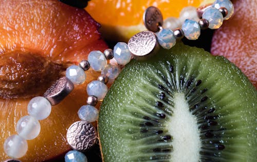 Free A Close-Up Shot of Fruits and a Jewelry Stock Photo