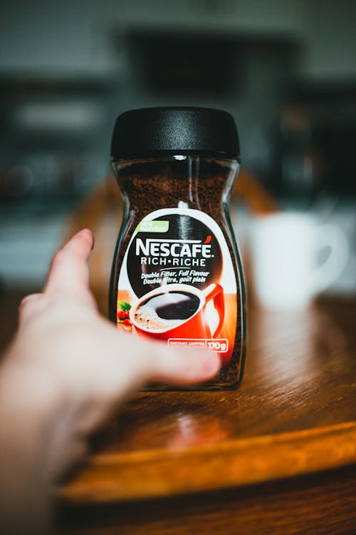 Free Person taking instant coffee jar Stock Photo